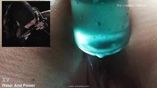 Violet is hooded, gagged and has her ass filled with two litres of water