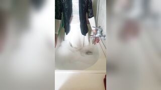 Wet clothes fan request in bathtub with bubbles and soap