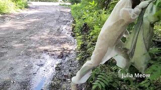 What is this crazy girl doing naked in a transparent jumpsuit on a busy road?