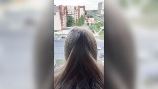 I fuck a girl while she stands on the balcony and looks out the window