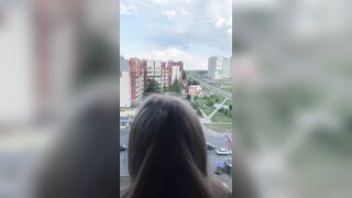 I fuck a girl while she stands on the balcony and looks out the window