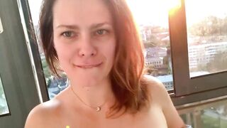 Horny MILF shakes her ass on the balcony fucks herself with a dildo squirting