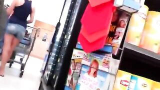 Sexy milf paying at the cashier