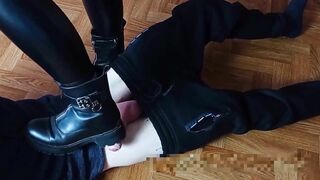 A girl in black boots jerks a guy's dick hard (foot fetish)