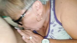 Grandma with glasses deepthroats and takes her young lover's entire cock in her mouth