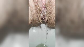 Hairy milf peeing in the toilet