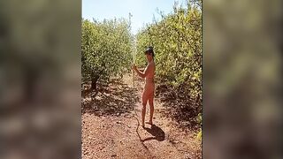 Naked woman showering in the open air.