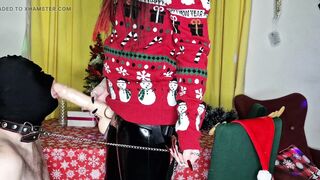 Dominatrix Nika congratulates her slave on Christmas with her big strap-on in his throat.