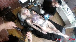 Sascha plays with Amber Luke while she gets tattooed