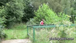 Peeing babes empty their bladders in a park being part of voyeur pee video