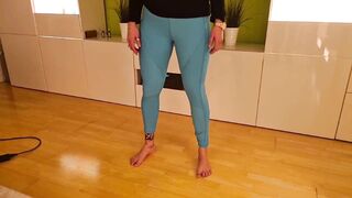 Hot milf pees in her leggings in the living room after her workout.